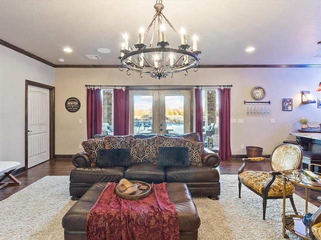 living room featuring french doors, a notable chandelier, dark hardwood / wood-style floors, and crown molding