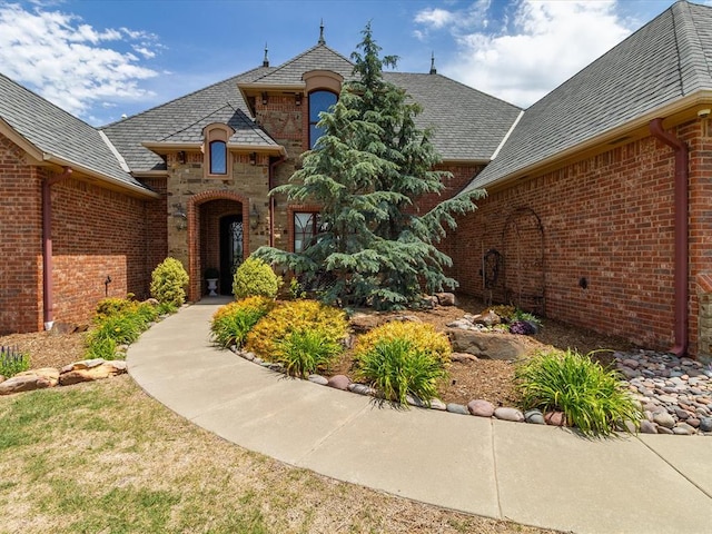 5451 Cottonwood Creek Cir, Norman, OK 73069 - view of exterior entry featuring brick siding