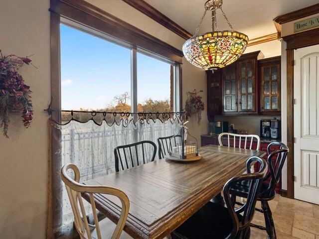 5451 Cottonwood Creek Cir, Norman, OK 73069 - dining room with light stone finish floors and ornamental molding