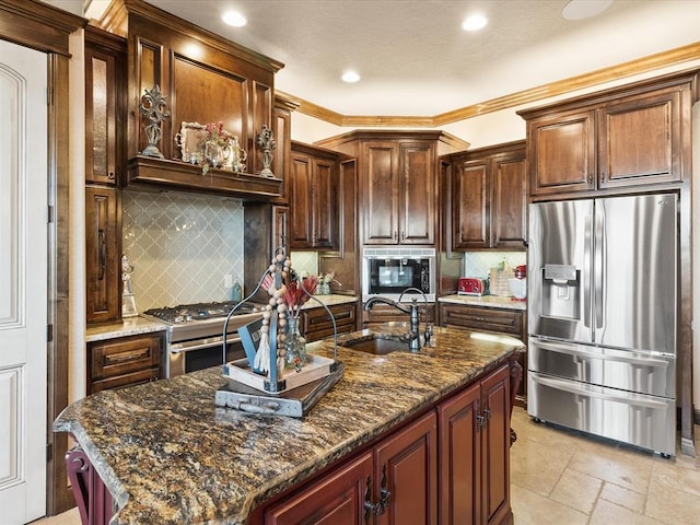 5451 Cottonwood Creek Cir, Norman, OK 73069 - kitchen featuring stainless steel appliances, a sink, recessed lighting, an island with sink, and dark stone counters