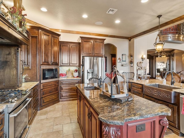 5451 Cottonwood Creek Cir, Norman, OK 73069 - kitchen with arched walkways, stainless steel appliances, a sink, decorative backsplash, and crown molding