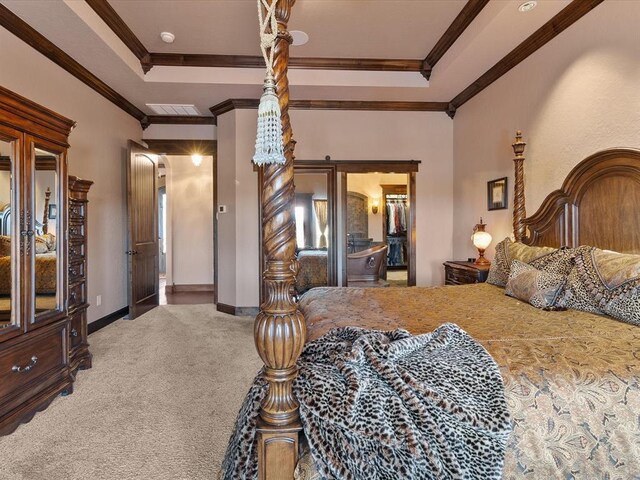 5451 Cottonwood Creek Cir, Norman, OK 73069 - bedroom featuring carpet flooring, ornamental molding, a tray ceiling, and baseboards
