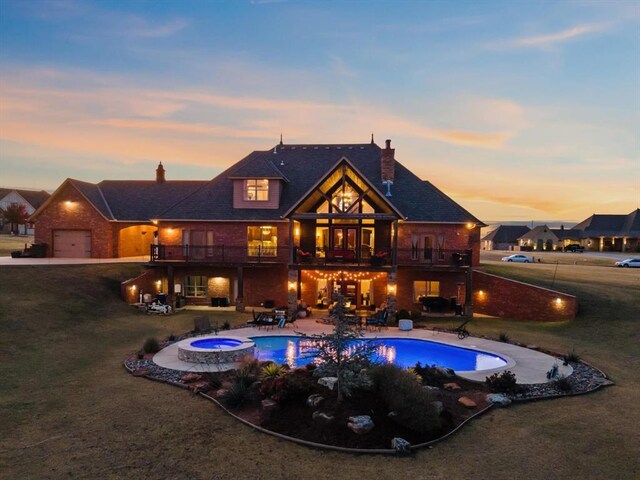 5451 Cottonwood Creek Cir, Norman, OK 73069 - pool at dusk with a lawn, a patio area, an in-ground hot tub, and an outdoor pool