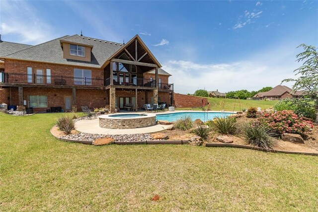 5451 Cottonwood Creek Cir, Norman, OK 73069 - back of property with brick siding, a yard, a patio, and a pool with connected hot tub