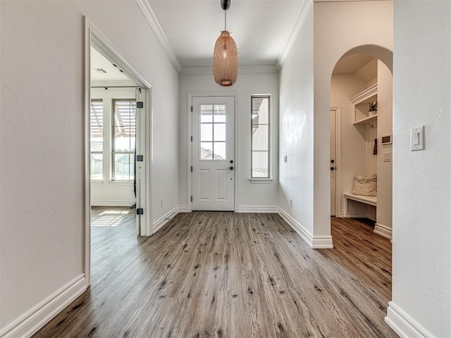 foyer entrance with light hardwood / wood-style flooring and crown molding