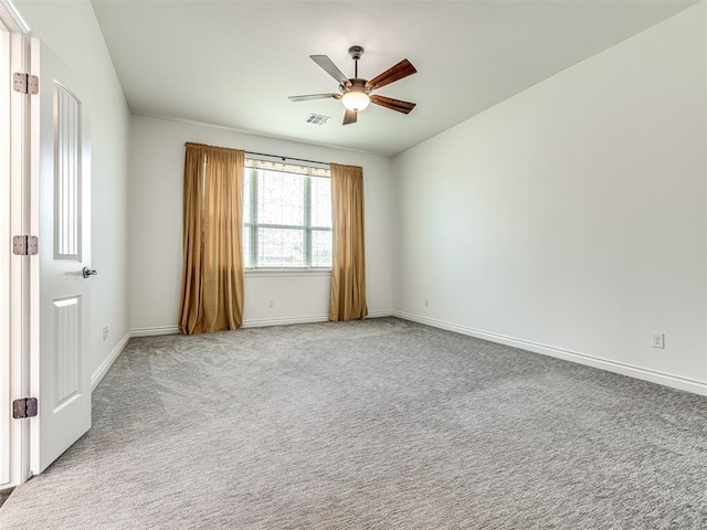 carpeted spare room with ceiling fan