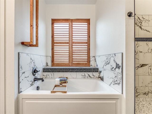 bathroom featuring shower with separate bathtub