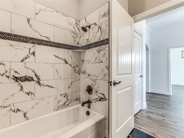 bathroom featuring hardwood / wood-style floors and tiled shower / bath