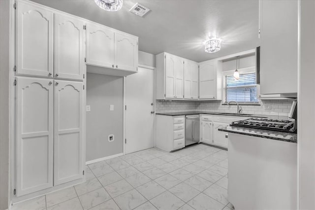 kitchen with dishwasher, sink, backsplash, pendant lighting, and white cabinets