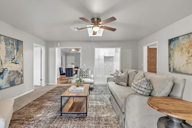 living room featuring carpet and ceiling fan