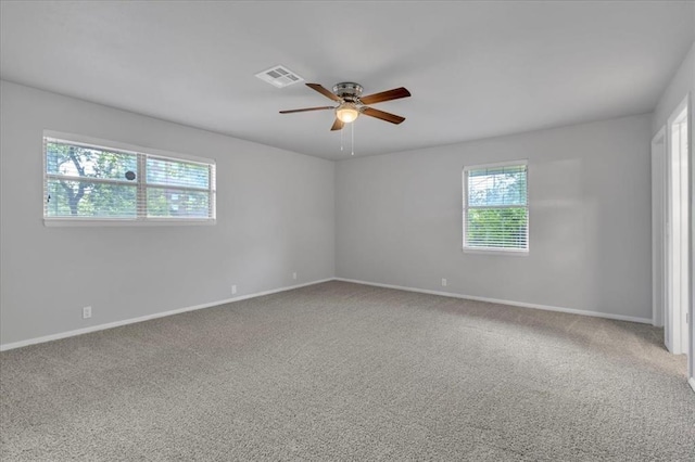 carpeted empty room featuring ceiling fan