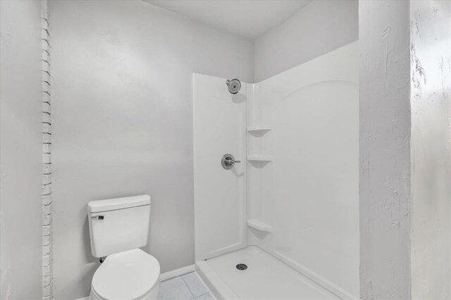 bathroom with a shower and toilet