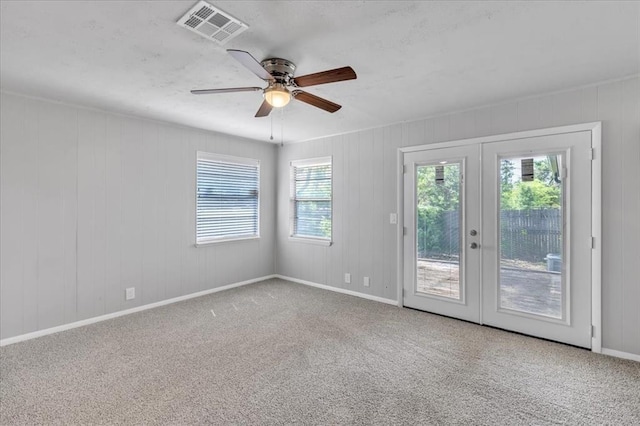 empty room featuring carpet flooring, ceiling fan, and french doors