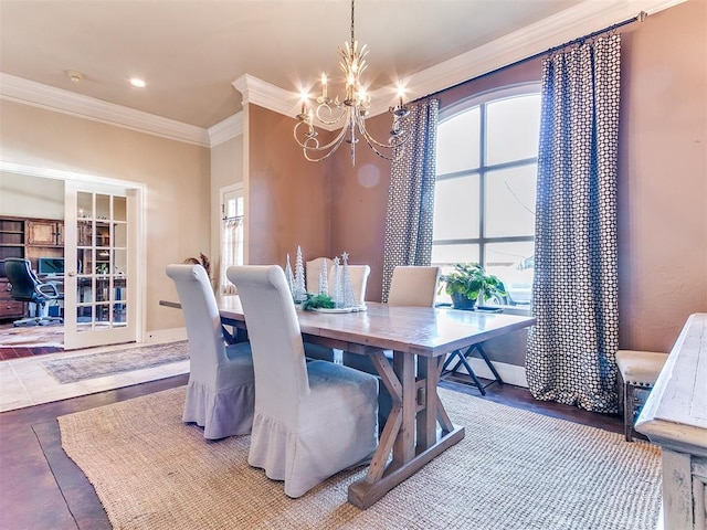 dining space featuring a chandelier, a wealth of natural light, and crown molding