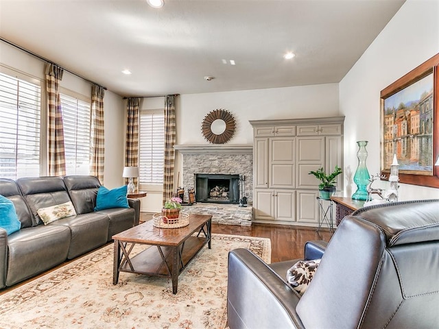 living room with light wood-type flooring and a fireplace