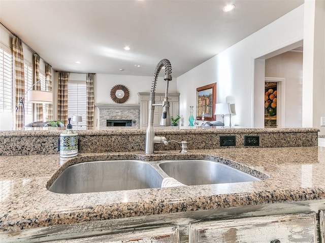 kitchen featuring light stone countertops and sink