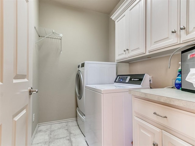 laundry area with cabinets and independent washer and dryer