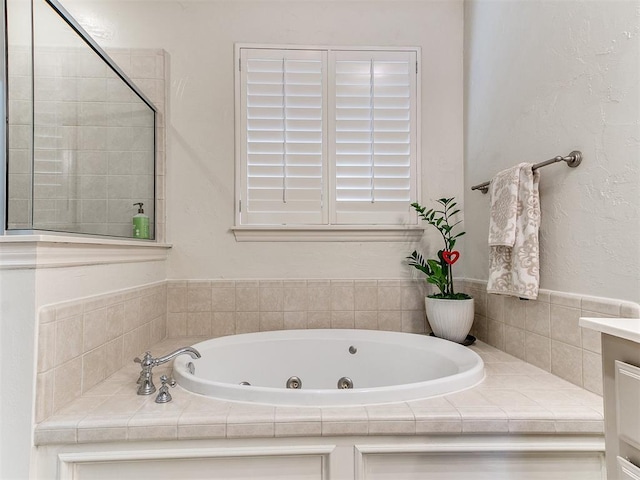 bathroom with a bathing tub and vanity