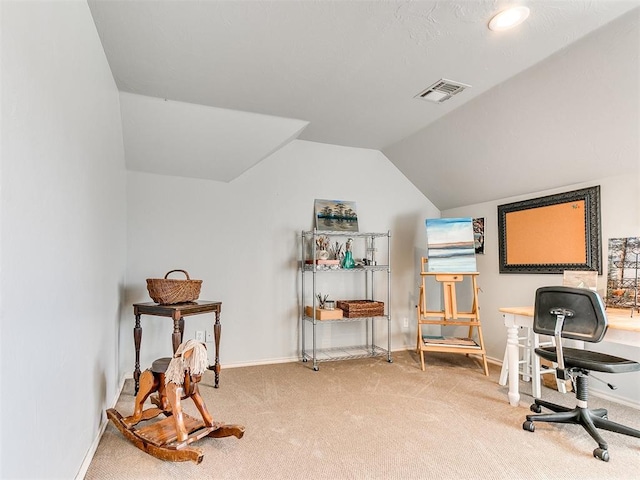 carpeted office featuring vaulted ceiling