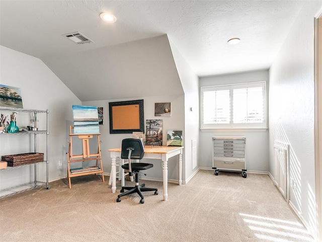 carpeted home office with lofted ceiling