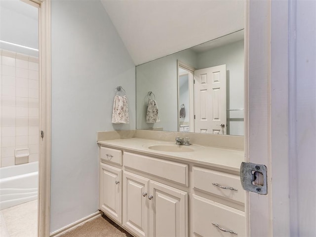 bathroom with vanity and vaulted ceiling