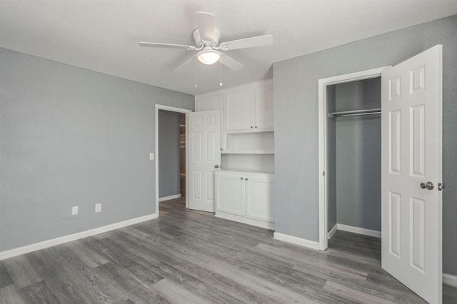 unfurnished bedroom featuring hardwood / wood-style flooring, a closet, and ceiling fan