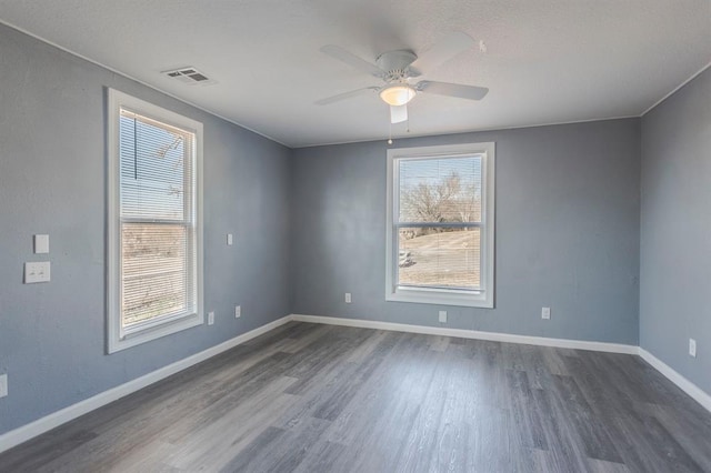 unfurnished room featuring dark wood-type flooring and ceiling fan