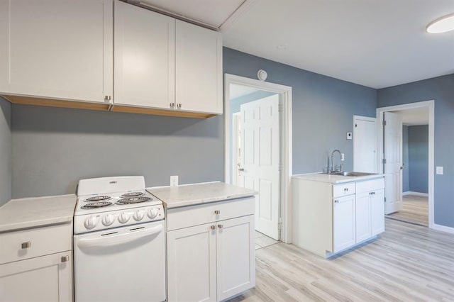 kitchen featuring sink, white cabinets, white range with electric stovetop, and light hardwood / wood-style floors