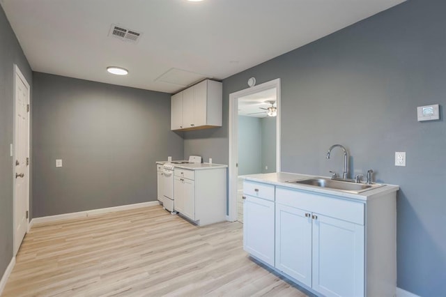 kitchen featuring sink, ceiling fan, white cabinetry, light hardwood / wood-style floors, and white range with gas cooktop