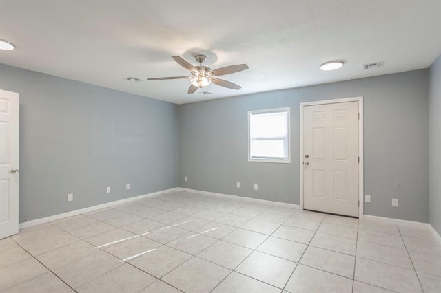 unfurnished room with light tile patterned floors and ceiling fan