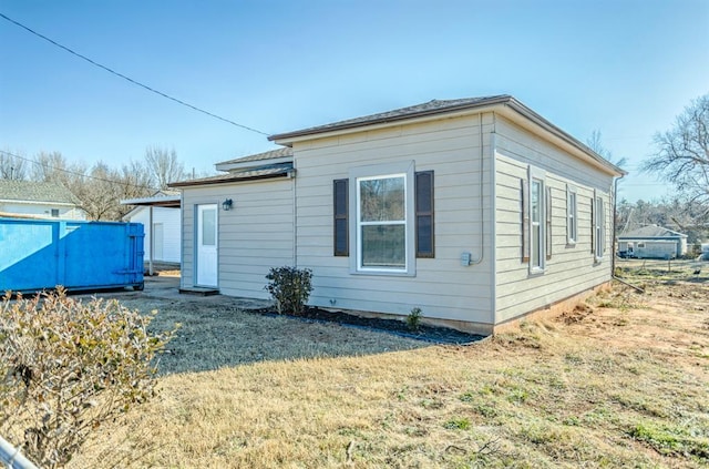 rear view of property featuring a yard