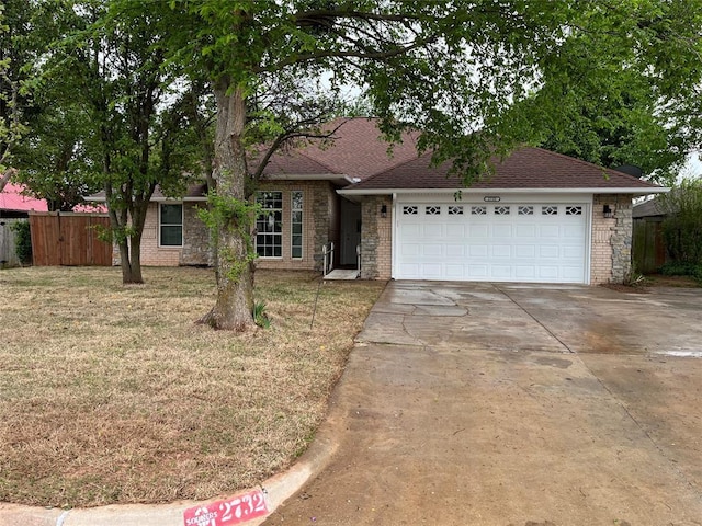 ranch-style house featuring a front yard and a garage