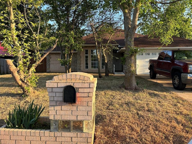 single story home with a garage and a front lawn