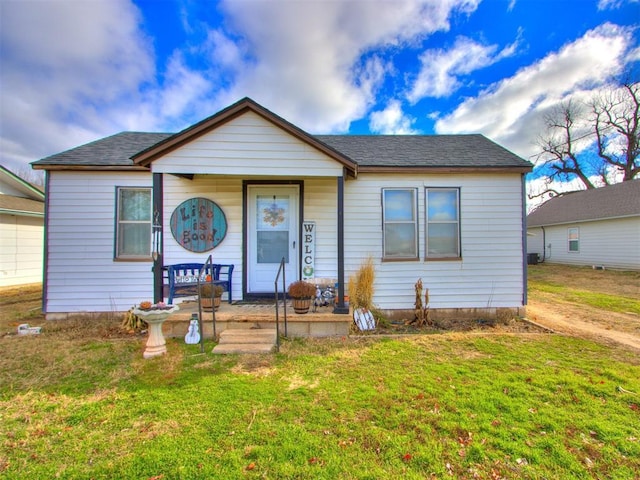 bungalow featuring a porch and a front lawn