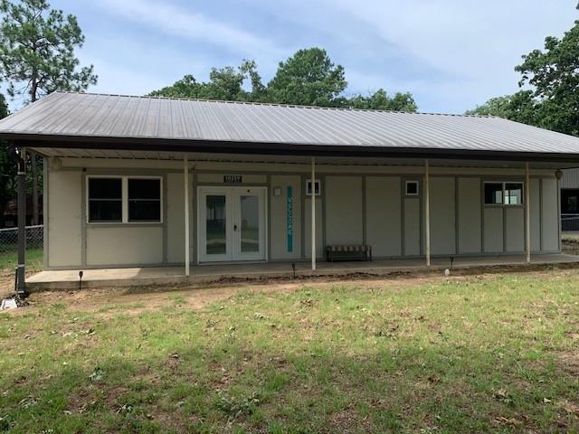 back of house with a porch and a yard