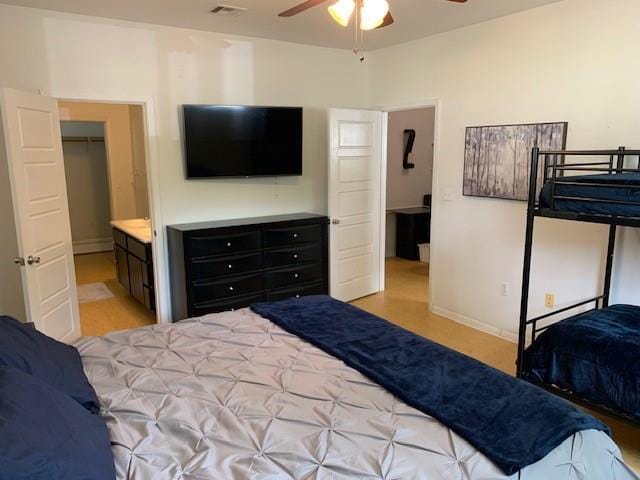 bedroom featuring ceiling fan, a closet, and ensuite bathroom