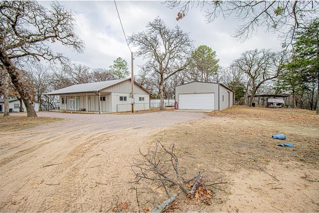 view of side of property featuring a garage and an outdoor structure