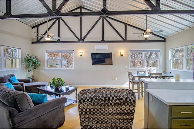 living room with ceiling fan, a healthy amount of sunlight, and light wood-type flooring