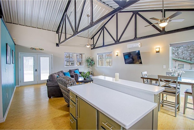 kitchen featuring a wall mounted air conditioner, light hardwood / wood-style floors, french doors, and ceiling fan