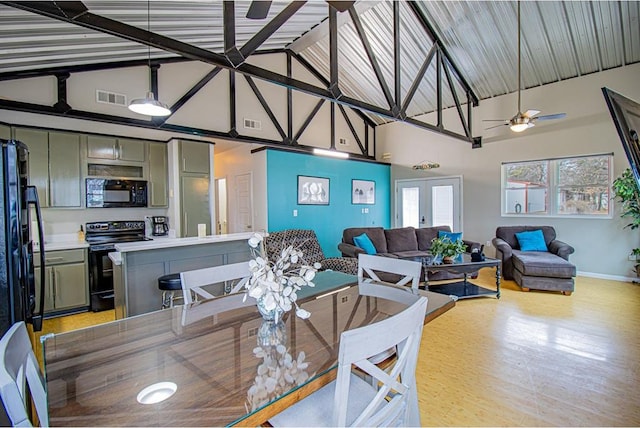 dining area with ceiling fan, high vaulted ceiling, light wood-type flooring, and french doors