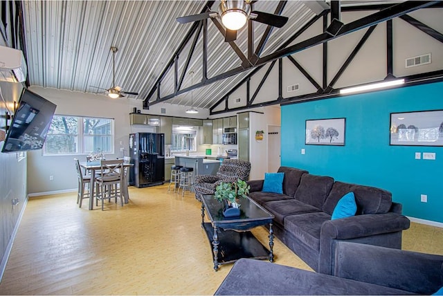 living room featuring a wall mounted air conditioner, high vaulted ceiling, ceiling fan, and light wood-type flooring