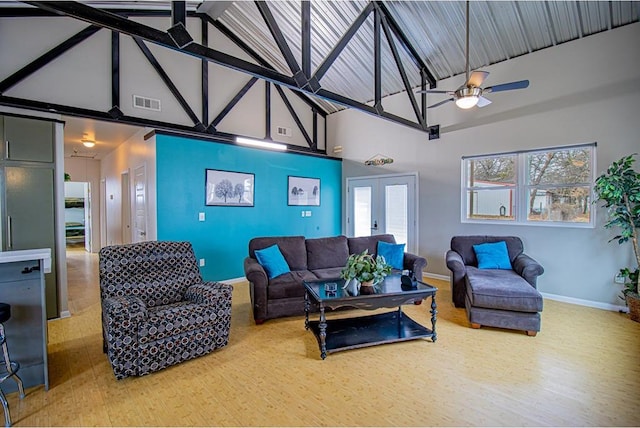 living room with hardwood / wood-style flooring, high vaulted ceiling, french doors, and ceiling fan