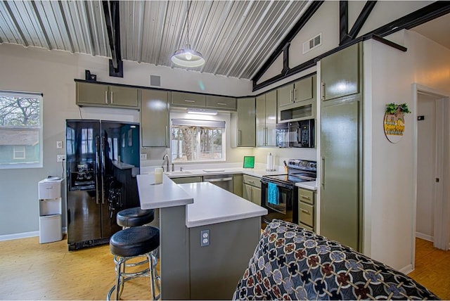 kitchen with lofted ceiling, sink, a healthy amount of sunlight, light hardwood / wood-style floors, and black appliances