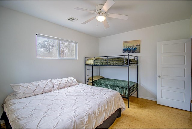 bedroom with ceiling fan and wood-type flooring