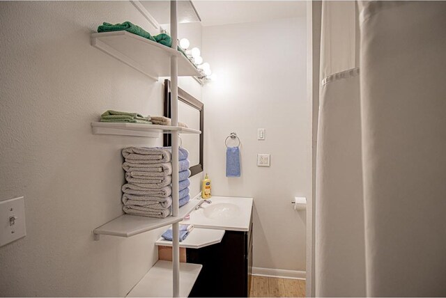 bathroom with vanity and wood-type flooring