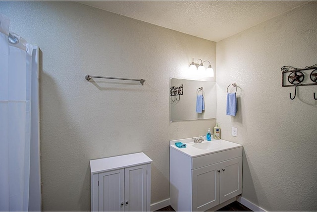 bathroom featuring vanity and a textured ceiling