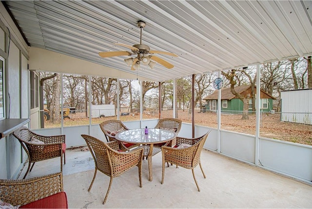 sunroom / solarium with ceiling fan, vaulted ceiling, and a healthy amount of sunlight