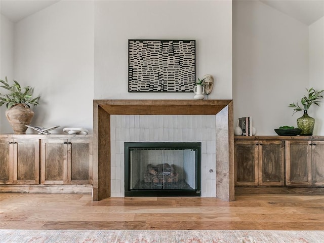 room details with a fireplace and hardwood / wood-style floors