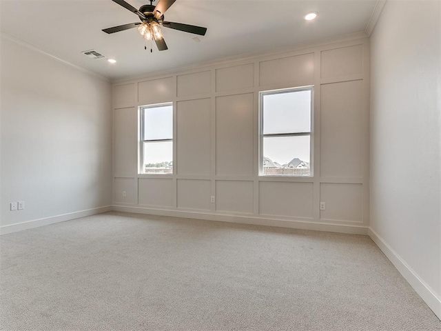 unfurnished room featuring light colored carpet, ceiling fan, and ornamental molding