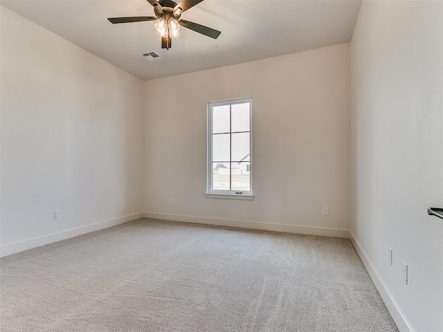 carpeted empty room featuring ceiling fan